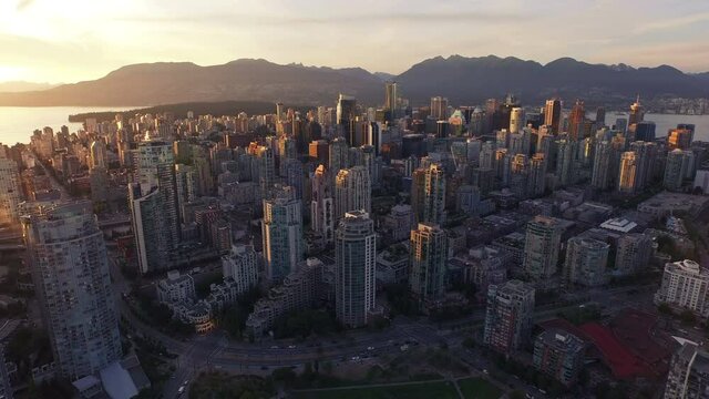 4K aerial vertical pan shot of Vancouver Skyline at sunset