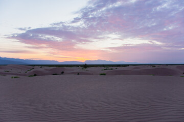 Sunset at empty desert dunes