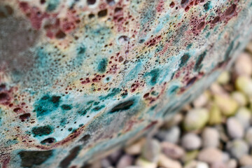 Closeup of a colourful boulder and pebbles