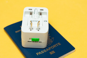 universal socket adapter over a passport with colored background