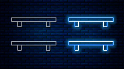 Glowing neon line Empty wooden shelves icon isolated on brick wall background. Vector