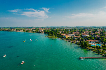 Naklejka na ściany i meble Aerial view of Sirmione resort coastline in Italy on the shore of Garda lake in Lombardy