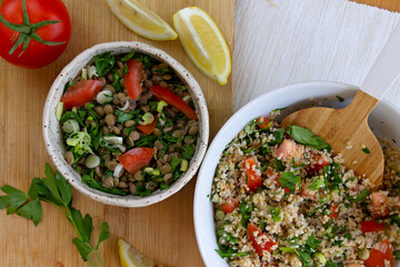 Tabbouleh salad and lentils on a wooden board.