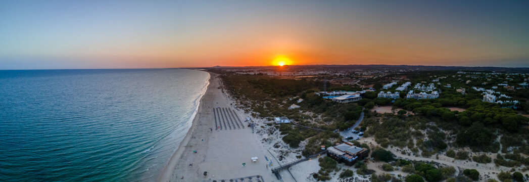 Aerial sunset seascape of famous Altura beach, Algarve.