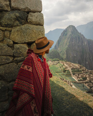 person in traditional clothes in poncho in machupicchu