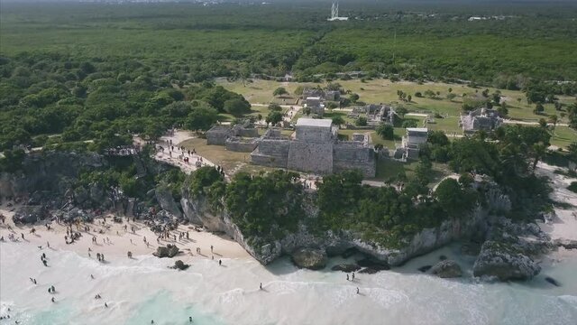4K Epic Aerial shot of Ancient Tulum Ruins Castle Mexico beach flying over ocean