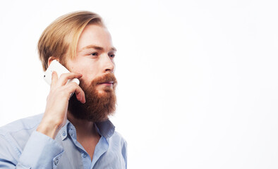 tehnology, internet, emotional and people concept: young bearded man talking on mobile