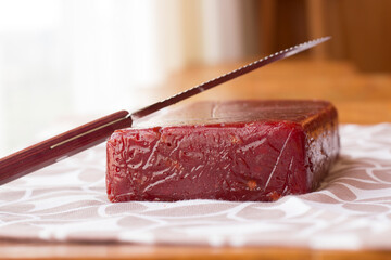 Brazilian guava dessert on the wooden table and a knife above it.