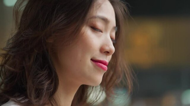 4k slow motion portrait of pretty young asian woman looking at camera smile