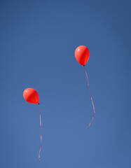 Red balloons, symbol of World Duchenne Awareness Day, are released into the blue open sky.