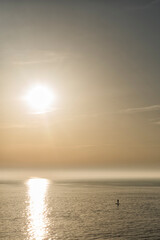 Silhouette of a man  paddle boarding during sunset