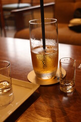 カフェのアンティーク風な店内　木製テーブルとお茶が入ったグラス