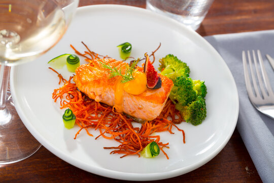 Fried Salmon Served On Pillow Of Smoked Julienne Carrot With Broccoli, Fresh Cucumber And Figs