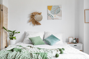 Stylish interior of modern bedroom with bedside table