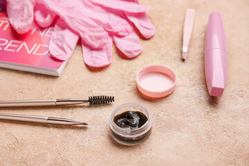 Fashion magazine, henna and tools for eyebrows correction on color background, closeup