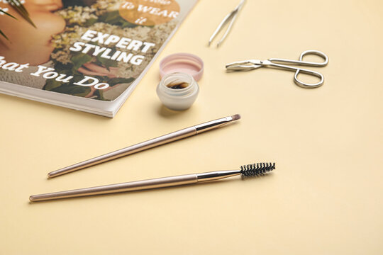 Fashion magazine, henna and tools for eyebrows correction on color background