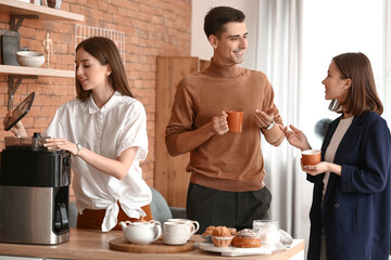 Business colleagues drinking coffee in office