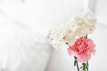 Bouquet of beautiful carnations in bedroom, closeup