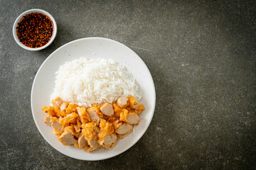 fried chicken topped rice with dipping sauce