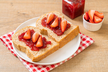 whole wheat bread with strawberry jam and fresh strawberry