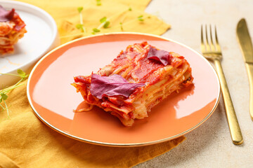 Delicious lasagna with tomato sauce in plate on table, closeup