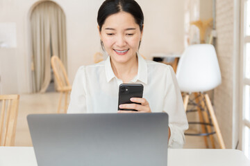 woman work using texting cell phone typing computer.study education online learning.adult...