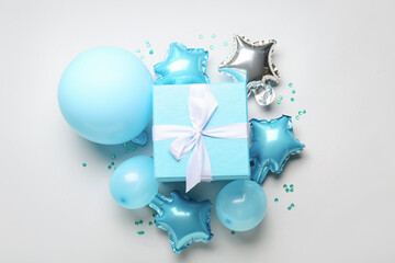 Gift box and air balloons on light background