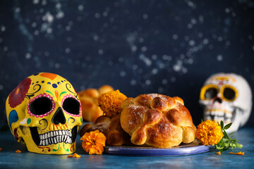 Bread of the dead and painted skull on color background. Celebration of Mexico's Day of the Dead (El Dia de Muertos)