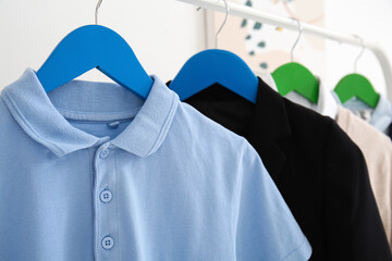 Rack with stylish school uniform in room