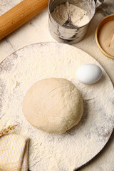 Composition with fresh dough on light background