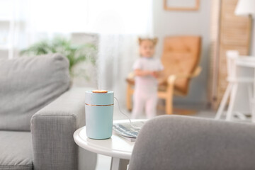 Modern humidifier on table in living room, closeup