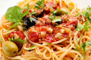 Tasty Pasta Puttanesca as background, closeup
