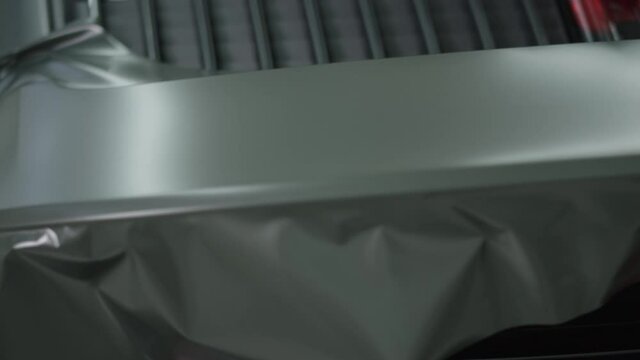 A vinyl car wrap is applied.