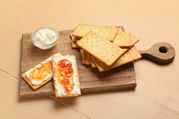 Delicious crackers with cottage cheese and jalapeno pepper jam on color wooden table