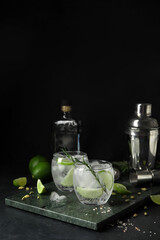 Glasses of cold gin and tonic on dark background