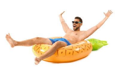 Young man with inflatable ring on white background