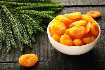 Delicious wild dried apricots served in ceramic bowl. sun dry fruits.
