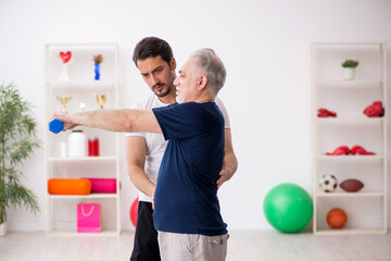 Young male instructor and old man doing sport exercises