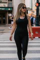 Outdoor fashion portrait of a stunning woman walking through the city