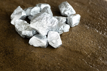 lump of silver or platinum on a stone floor - obrazy, fototapety, plakaty