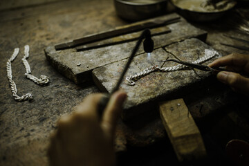 Jeweler at work in jewelry. Desktop for craft jewelry making with professional tools. Close up view...