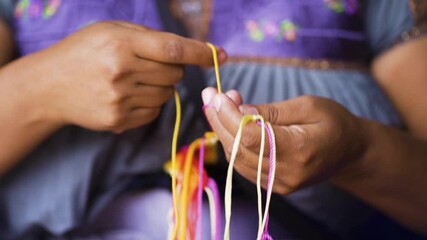 detail of woman's hands embroidering typical regional clothing. unrecognizable woman in rural teinda