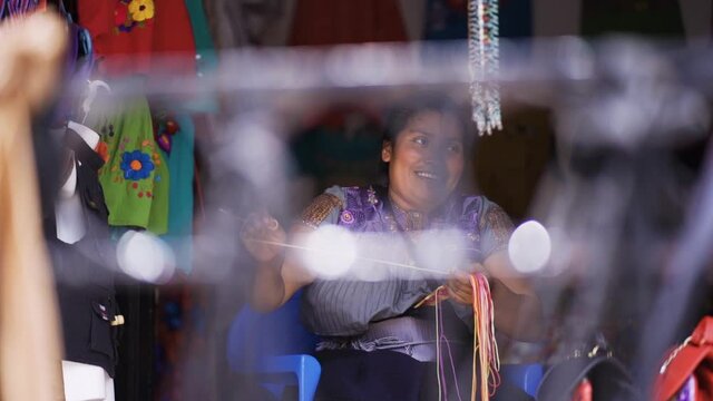 happy latin woman working. Mexican woman smiling and working in typical clothing store