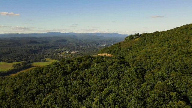 Aerial drone footage of a beautiful scenic highway in the Appalachian mountains during late summer or early autumn at sunset. This is in the Shawangunk Mountains, new york, hudson valley.