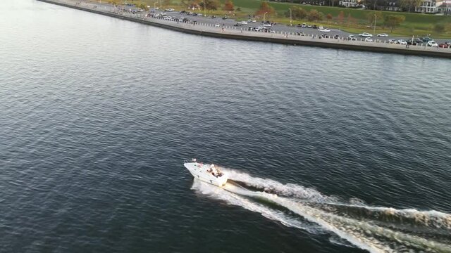 Speedboat Leaving Wake On Calm Waters Of Lake During Sunset. - aerial