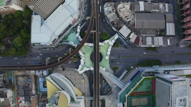 Aerial view of Siam Bangkok Art and Skywalk aerial view in MBK Culture Center intersection or junction with cars traffic skyscraper buildings. Bangkok City in downtown at night, Thailand