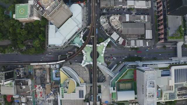 Aerial view of Siam Bangkok Art and Skywalk aerial view in MBK Culture Center intersection or junction with cars traffic skyscraper buildings. Bangkok City in downtown at night, Thailand