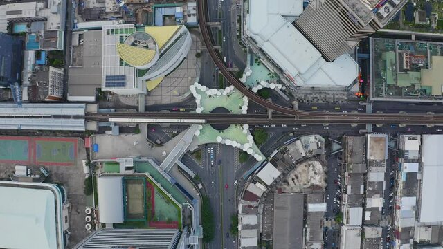 Aerial view of Siam Bangkok Art and Skywalk aerial view in MBK Culture Center intersection or junction with cars traffic skyscraper buildings. Bangkok City in downtown at night, Thailand
