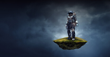 Astronaut walking on an unexplored planet . Mixed media