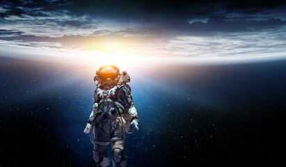 Astronaut walking on an unexplored planet . Mixed media